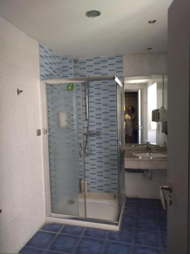 a bathroom with a shower and a sink at A Parada do Camiño in Padrón