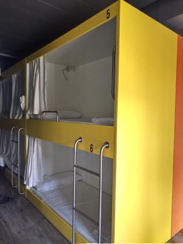 a yellow bunk room with two bunk beds at A Parada do Camiño in Padrón