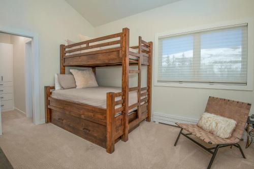 a bedroom with a bunk bed and a chair and a window at 1536-A Deer Blvd in Avon
