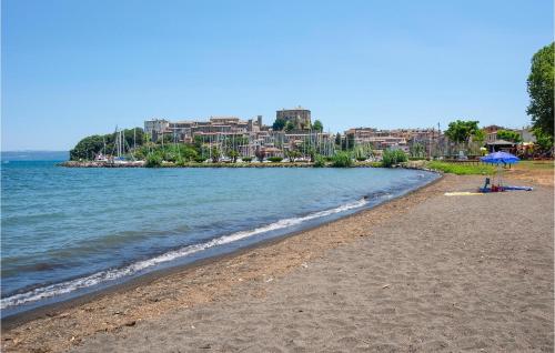 a sandy beach with a city in the background at Beautiful Apartment In Loc, Scalabrelli in Catabbio