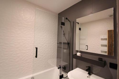 a bathroom with a shower and a toilet and a sink at Chalet Niyama in Font-Romeu-Odeillo-Via
