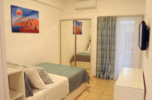 a hotel room with a bed and a window at Sunset by the sea 2 in Loutraki