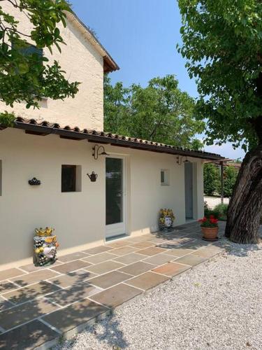 a house with a stone patio in front of it at Casa Bellona in Montebelluna
