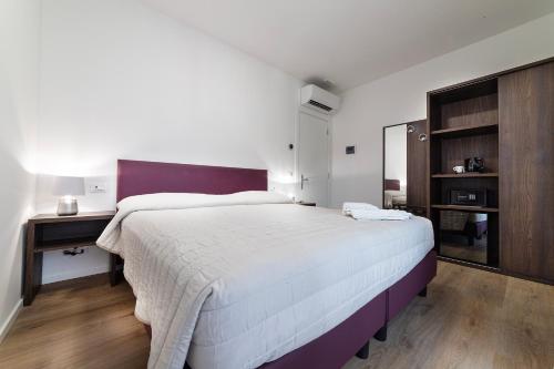 Castelli del Chianti في غايولي إن كيانتي: غرفة نوم بسرير ابيض كبير ومرآة