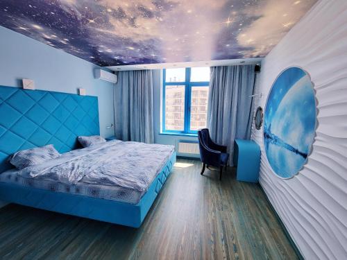 a bedroom with a blue bed and a star ceiling at Odessa arkadiya 4 room and Jacuzzi Lux in Odesa