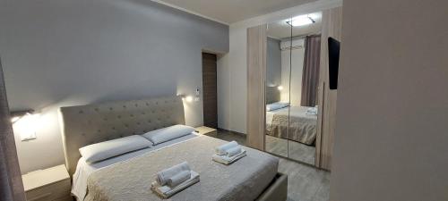 a bedroom with a large bed and a mirror at MCM in Rome