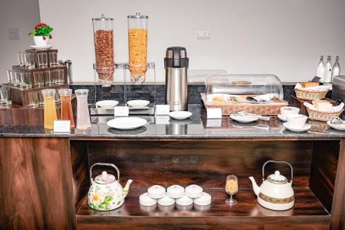 a kitchen counter with food and dishes on it at Regenta Resort MARS Valley View Shoghi in Shimla