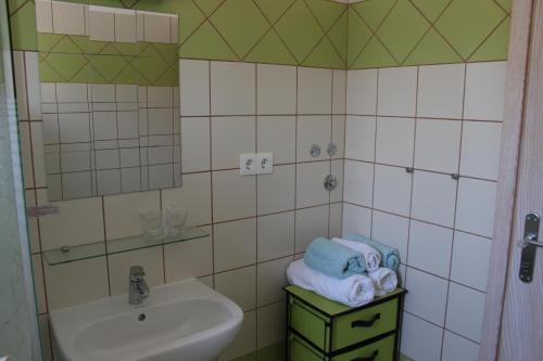 a bathroom with a sink and a toilet and towels at Studio Lavanda in Kornić, Krk in Kornić