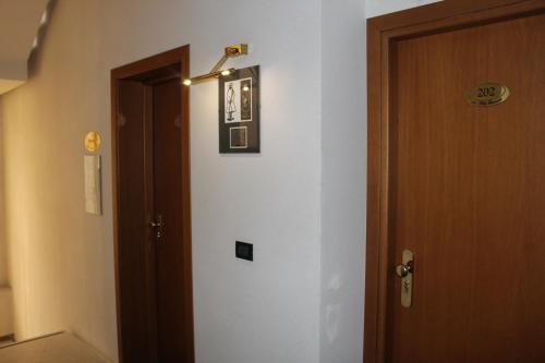 a room with a door and a picture on the wall at Arcangelo Roof Hotel in Rimini