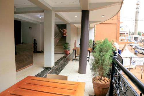 a balcony of a building with a table and chairs at Scindia Suites hotel in Jinja
