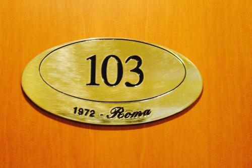 a metal plate with the number on a wall at Arcangelo Roof Hotel in Rimini