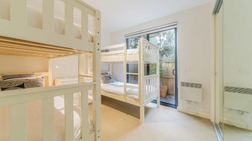 a room with two bunk beds and a window at 4-4 The Esplanade, Cowes - Cscape in Cowes