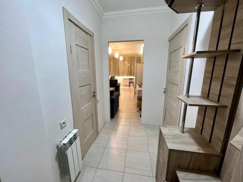 a hallway with two white doors and a living room at Luxuary Apartment in Yerevan,Centre,Saryan Street in Yerevan