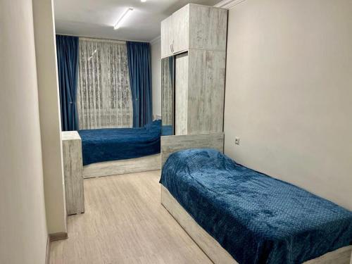 a bedroom with two beds and a large window at Luxuary Apartment in Yerevan,Centre,Saryan Street in Yerevan