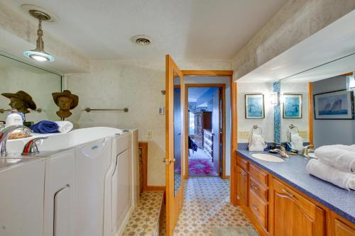 a bathroom with a sink and a counter top at Lakefront Cadillac Retreat with Sauna and Boating! in Cadillac