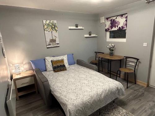 a bedroom with a bed and a table and chairs at Stardust Getaway E32R670 in Piltown