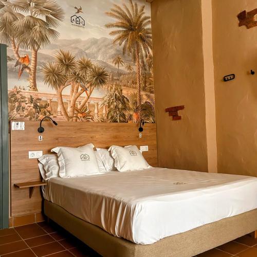 a bedroom with a bed with a painting on the wall at ANJ ESTUDIO TEMPLETE in Guadalupe