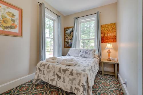a bedroom with a bed with two towels on it at Spacious Victorian Home quarter Mi to Holiday Valley! in Ellicottville
