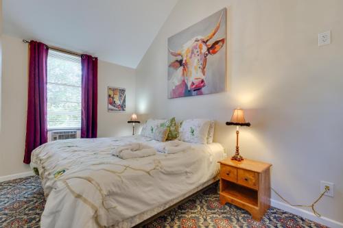 a bedroom with a bed and a picture of a cow on the wall at Spacious Victorian Home quarter Mi to Holiday Valley! in Ellicottville