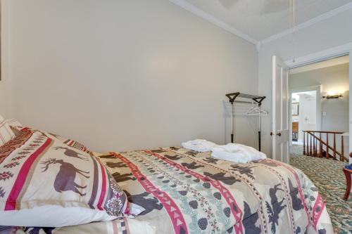 a bedroom with a bed with a blanket on it at Spacious Victorian Home quarter Mi to Holiday Valley! in Ellicottville
