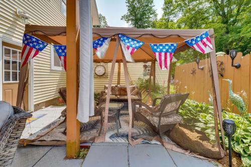 a gazebo with american flags on a patio at Spacious Victorian Home quarter Mi to Holiday Valley! in Ellicottville