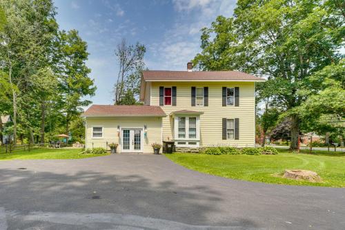 a yellow house with a red window and a driveway at Spacious Victorian Home quarter Mi to Holiday Valley! in Ellicottville