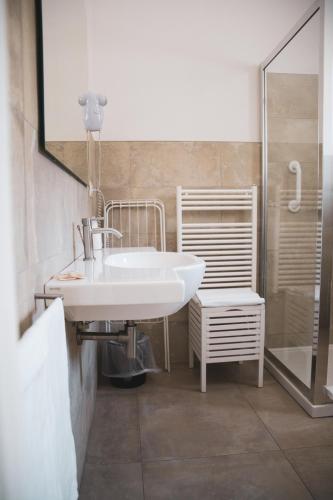 a bathroom with a white sink and a shower at Agriturismo Giorgio in Mattinata