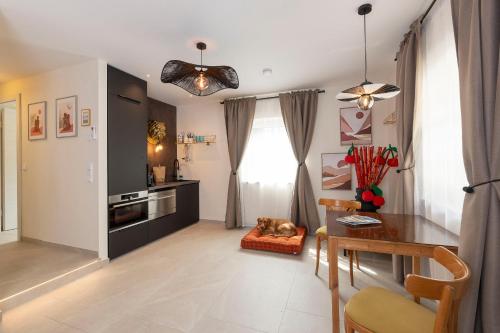 a living room with a table and a dining room at City Apartments Wolfgangsee in St. Wolfgang