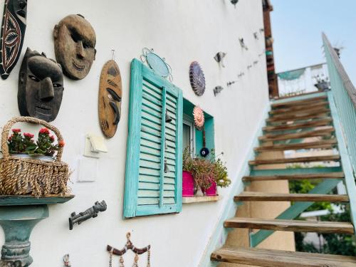 a wall with a blue window and a staircase at Zehava's Zimmer in Ein Gedi