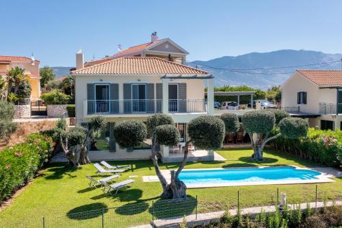 a villa with a swimming pool and a house at Villa Metaxata in Argostoli