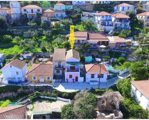 an aerial view of a house with a yellow arrow on it at Odysseos St. Loft in Vathi