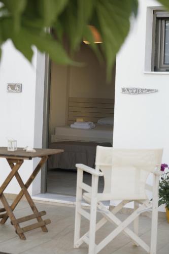 a room with a table and a chair and a bed at Asterias in Skiros