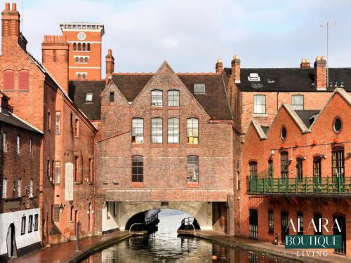 an old building with a bridge over a canal at 3 Floor Townhouse Luxury Living Alara Boutique in Birmingham