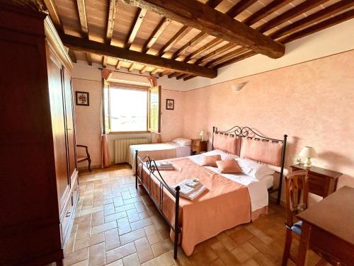 a bedroom with a bed and a large window at Poggiosalto in Toscana in Pienza