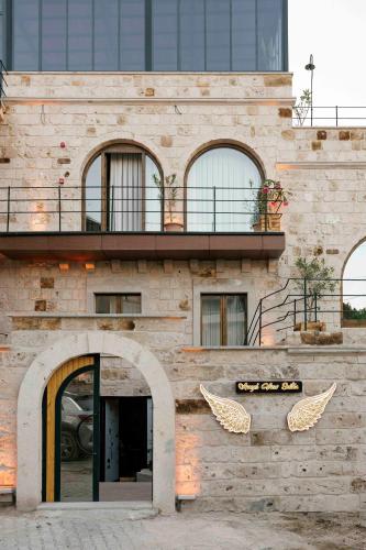 a brick building with a balcony and an entry way at Angel View Suites in Goreme