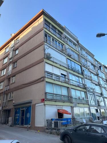 a tall building with a car parked in front of it at Mükemmel Deniz Manzaralı Lüks in Istanbul