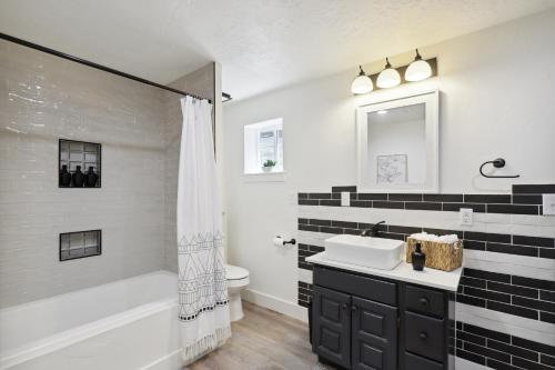 a bathroom with a sink and a tub and a toilet at Family-Friendly Provo Vacation Rental Near BYU! in Provo