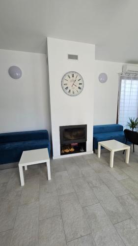 a living room with a couch and a clock on the wall at Fantastic camp in Piteşti