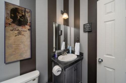 a bathroom with a sink and a mirror at Brand New Lake Travis Estate - Awesome Pool in Austin