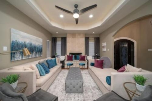a large living room with couches and a fireplace at Brand New Lake Travis Estate - Awesome Pool in Austin