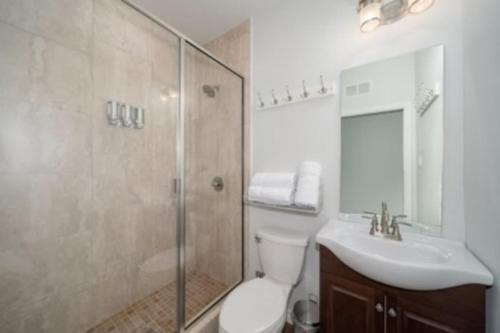 a bathroom with a toilet and a sink and a shower at Brand New Lake Travis Estate - Awesome Pool in Austin