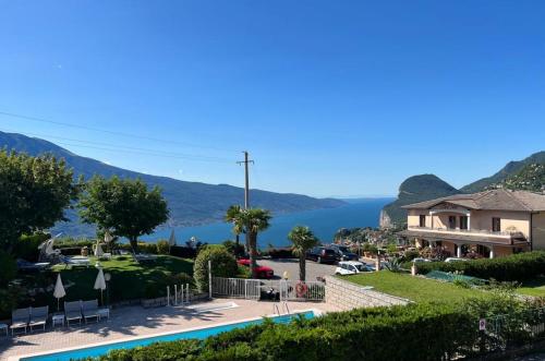 a view of a resort with a pool and a house at Hotel Garni Bel Sito in Tremosine Sul Garda