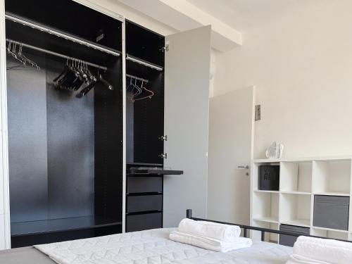 a bedroom with a bed and a large closet at Luxury Apartment next to the Francescana in Modena