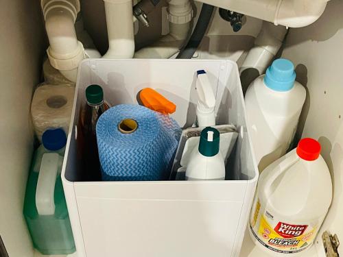 a refrigerator filled with dishes and bottles of milk at City Hidden Gem in Melbourne