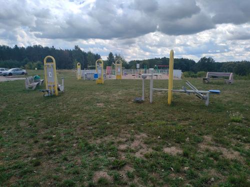 a group of playground equipment in a field at Apartament Szpitalna in Suwałki