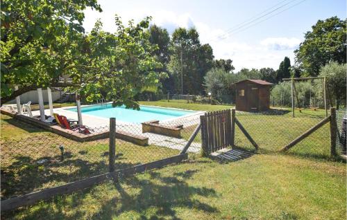 a fence around a swimming pool in a yard at Villa Marisa in Monteverdi Marittimo