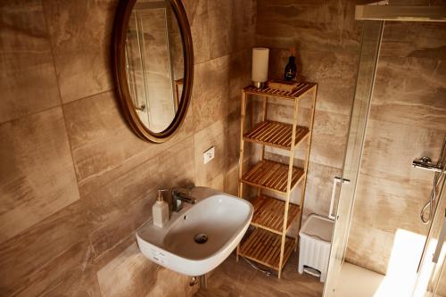 a bathroom with a sink and a mirror at Il Torrione del Trebbia in Bobbio