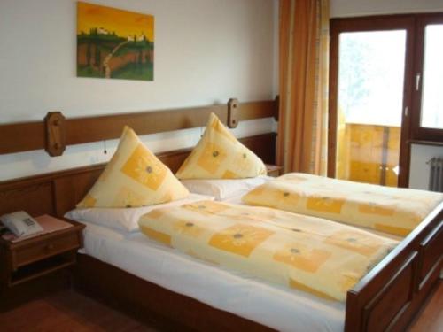two twin beds in a room with a window at Gästehaus-Pension Bendler in Kirchdorf in Tirol