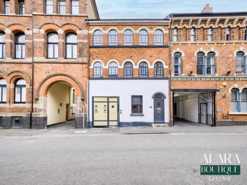 a large brick building with doors and a garage at 3 Floor Townhouse Luxury Living Alara Boutique in Birmingham