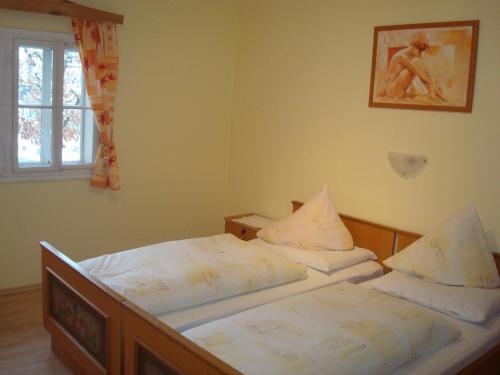 two twin beds in a bedroom with a window at Gästehaus-Pension Bendler in Kirchdorf in Tirol